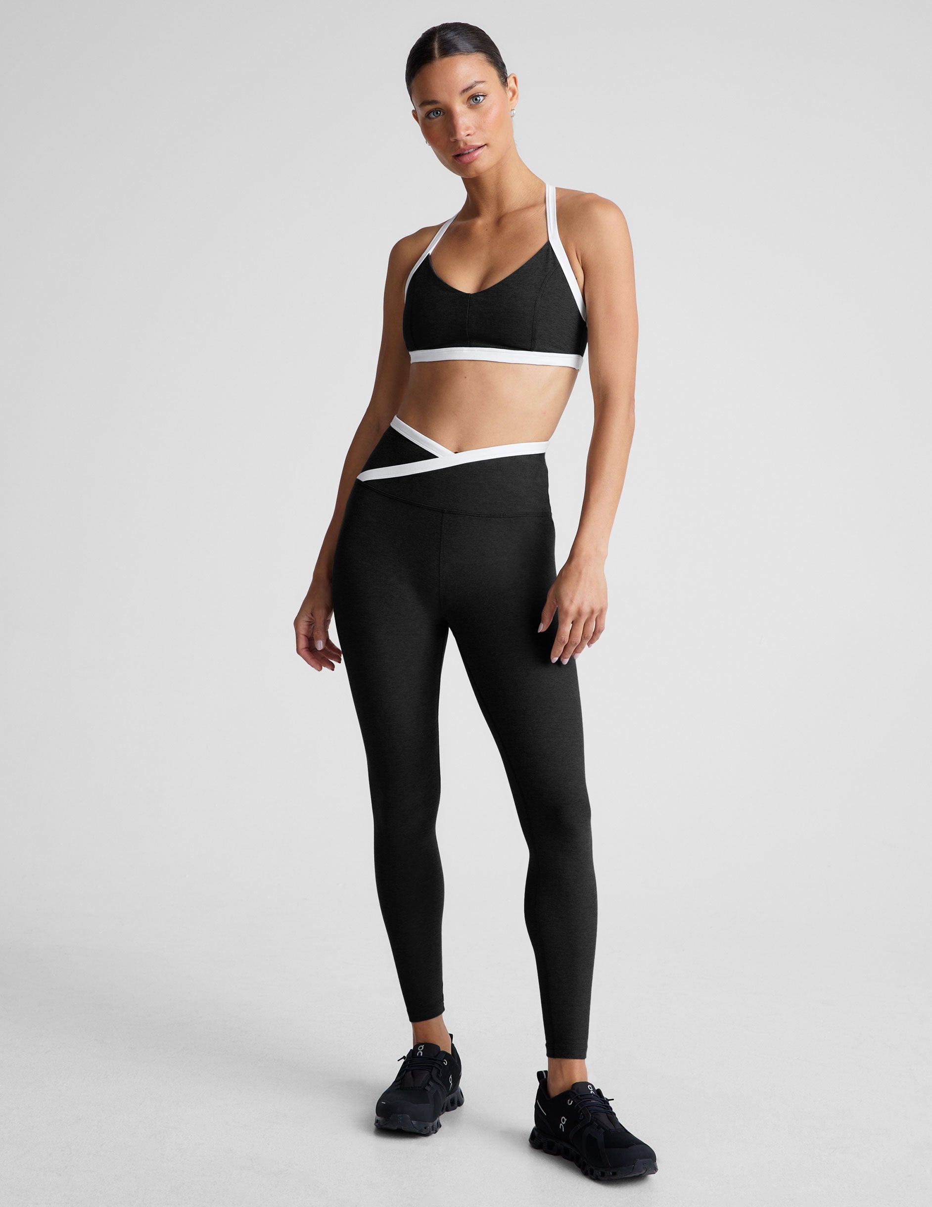 black v-neck racerback bra top with princess seams and white contrast lining.