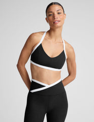 black v-neck racerback bra top with princess seams and white contrast lining.