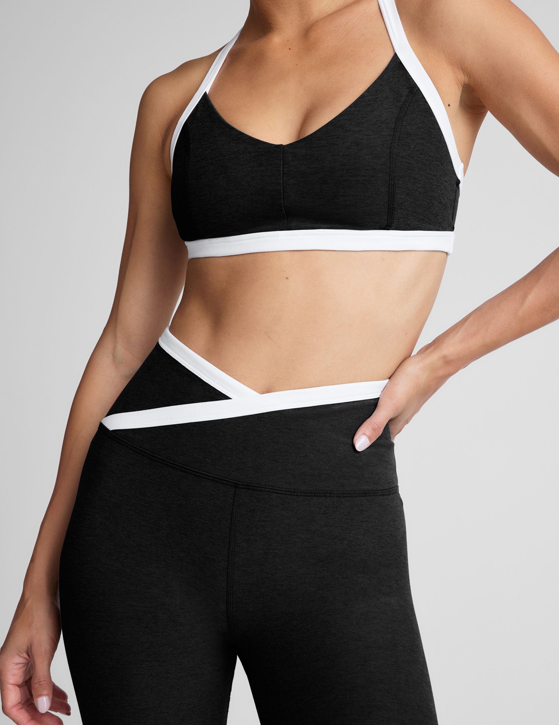 black v-neck racerback bra top with princess seams and white contrast lining.