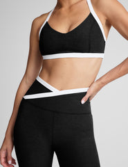 black v-neck racerback bra top with princess seams and white contrast lining.