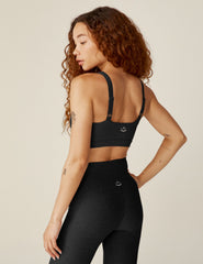 black sports bra with remove-able pads and adjusting straps.