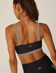 black v-neck bra top with brown outlining details.