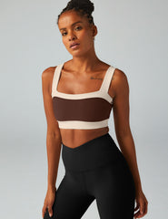 brown square neck bra top with white outlining.