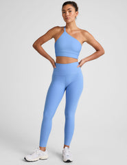 blue long line length bra with a one strap detail and an open back.