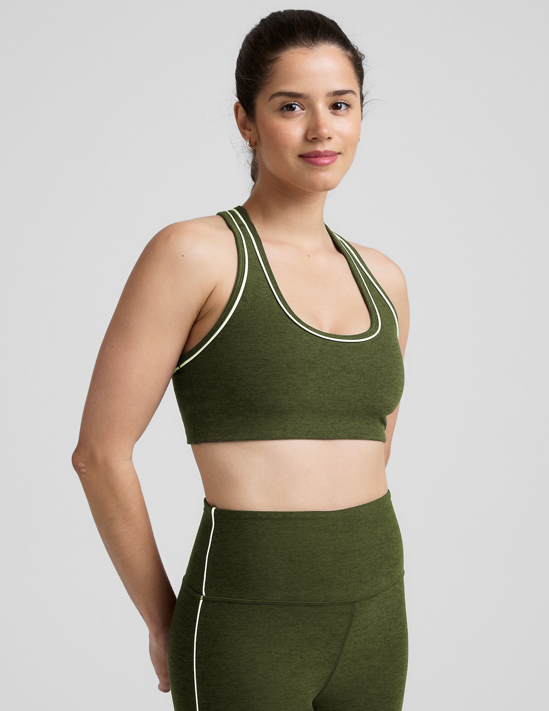 green racerback bra with white contrast trim.
