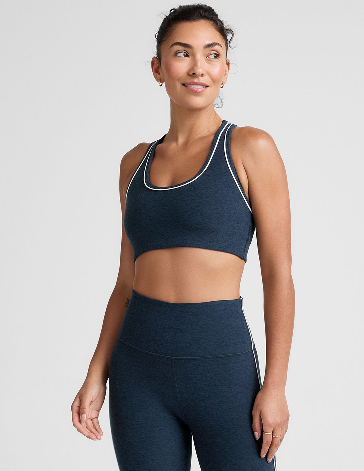 blue scoop neck racerback bra with white contrast trim.