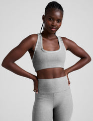 grey scoop neck racerback bra with white contrast trim.