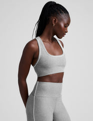 grey scoop neck racerback bra with white contrast trim.