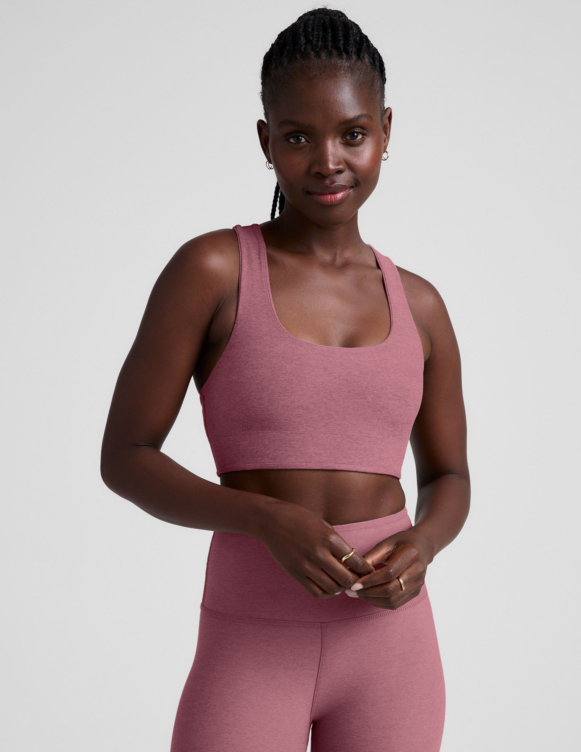 model is wearing a pink scoop neck racerback long line bra.