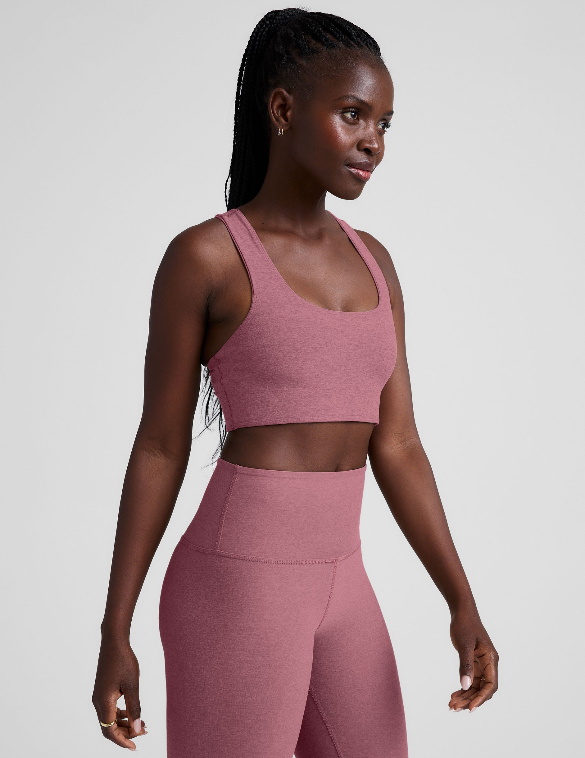 model is wearing a pink scoop neck racerback long line bra.