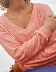 pink v-neck terry fabric long sleeve pullover.