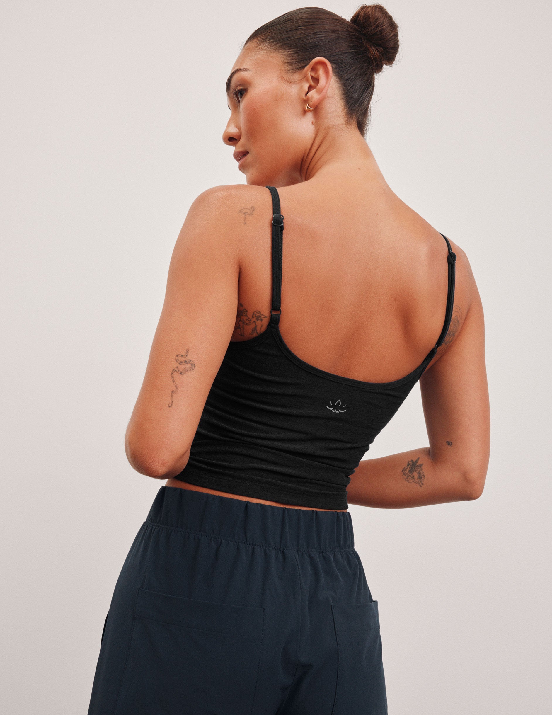 black midway length tank top with adjustable spaghetti straps.