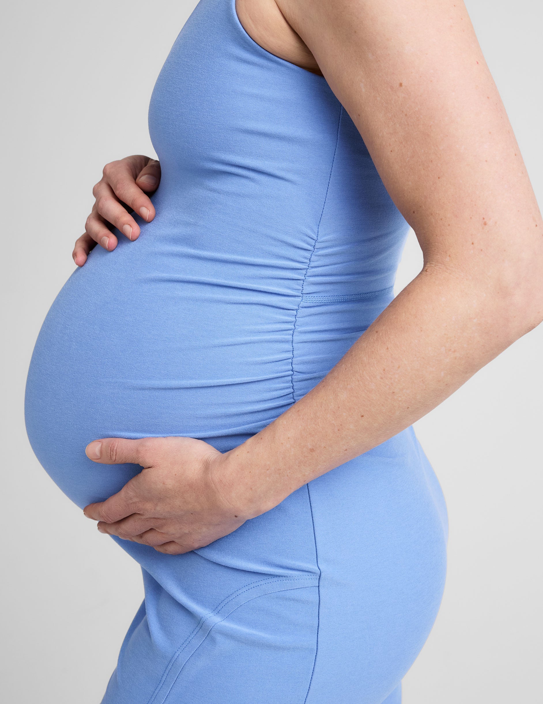 blue midi length maternity dress with a v-neckline and side slit.