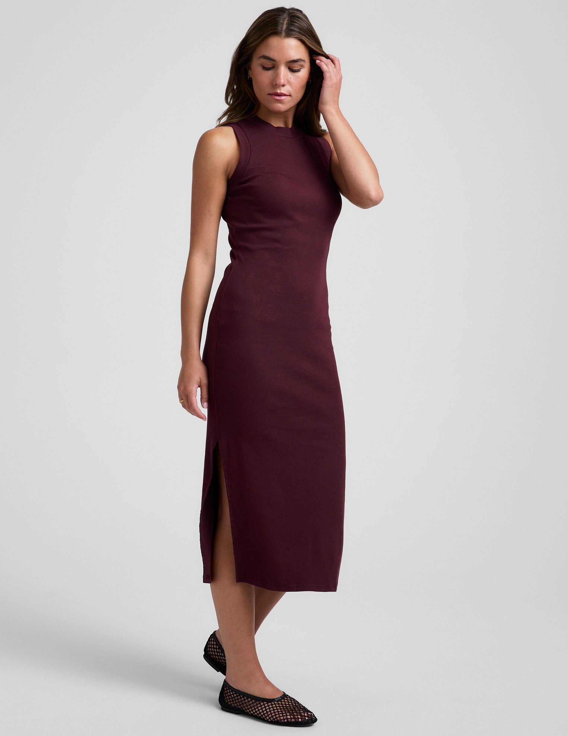 red midi length ribbed dress with side slits and a mock neckline.