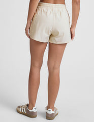 white mid-rise shorts with two side patch cargo pockets and a drawcord at waistband.
